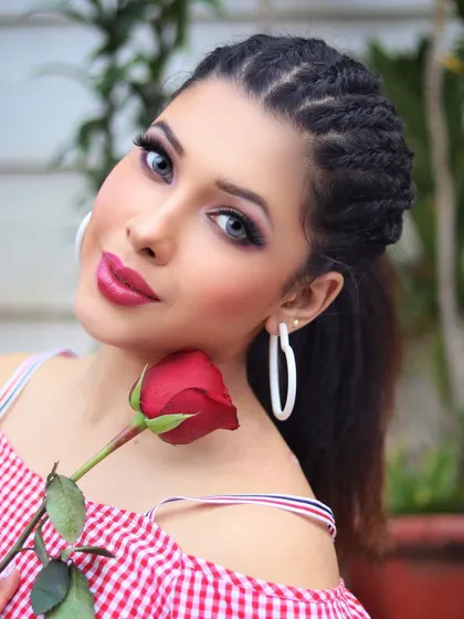 A romantic glam look featuring intricate cornrow braids and a bold lip. The makeup is kept clean and sharp to complement the detailed hairstyle, making it a great option for a creative photoshoot.