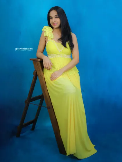 A graceful seated pose in the yellow party dress. This versatile piece is available for rent at an unbelievable price.