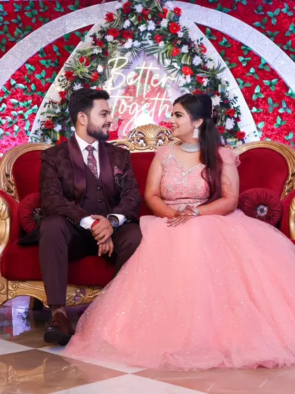 A sweet moment with the couple seated on a grand red sofa, under a "Better Together" sign. It’s a perfect blend of posed and candid.