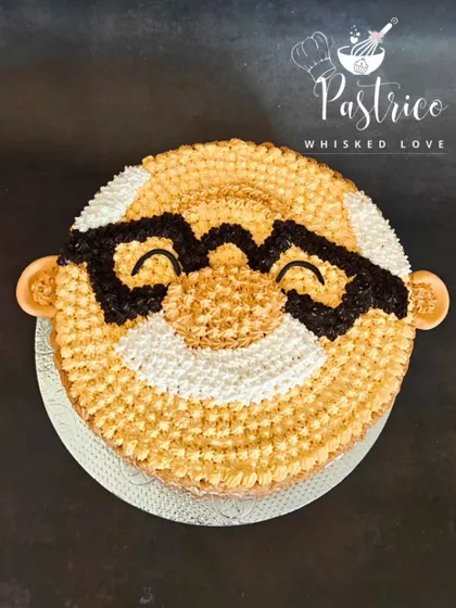 A top-down view of the grandpa-themed cake, showing the texture and detail of the star-nozzle piping work.