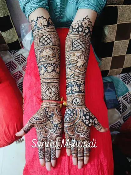 A classic bridal design with a mix of floral and geometric patterns. The use of dark and light shading gives the design a lot of depth and dimension.