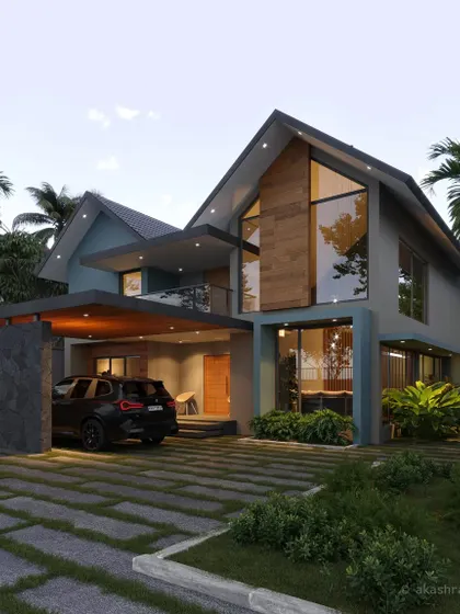 A large home in Kannur with a distinctive blue-grey exterior, large glass windows, and a prominent gabled roof section.