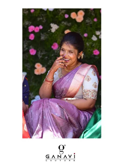 A candid, happy moment featuring Nandu in her custom blouse. Her genuine smile is the highlight of this photo, showing the joy that a beautiful, well-crafted outfit can bring.