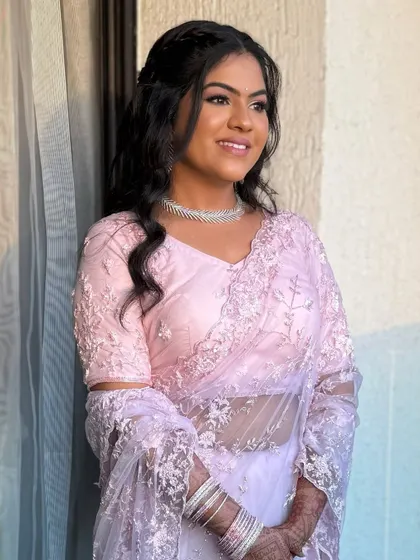 The bride in her beautiful pastel saree, her makeup glowing in the soft light. This is the essence of modern elegance.