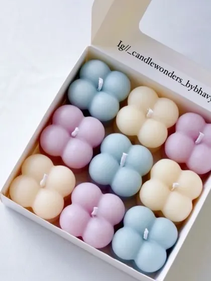 A box of pastel-colored mini bubble candles, perfect for birthday return gifts.