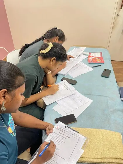 A group of healthcare professionals diligently working on their training materials. My programs are designed to fit into busy work schedules, with a mix of online and in person sessions.
