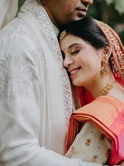 A tender moment between the bride and groom. The bride's beautiful smile and the intricate details of her traditional saree are what make these memories so precious. We create the space for these moments to happen.