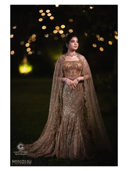 Sindhu looking ethereal in her caped gown. The makeup is soft and romantic, with a focus on glowing skin that looks beautiful against the night backdrop.
