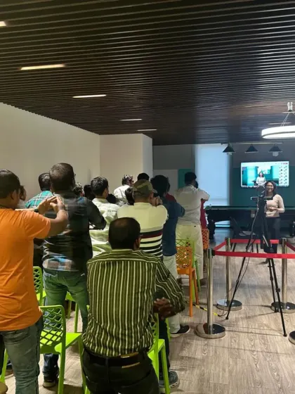 Participants in a chair yoga class performing gentle neck and shoulder stretches to alleviate stiffness from computer work.