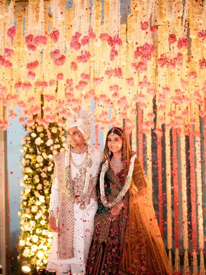 A shower of petals marks the union. The vibrant colors of the flowers against their elegant outfits created a picture-perfect memory.