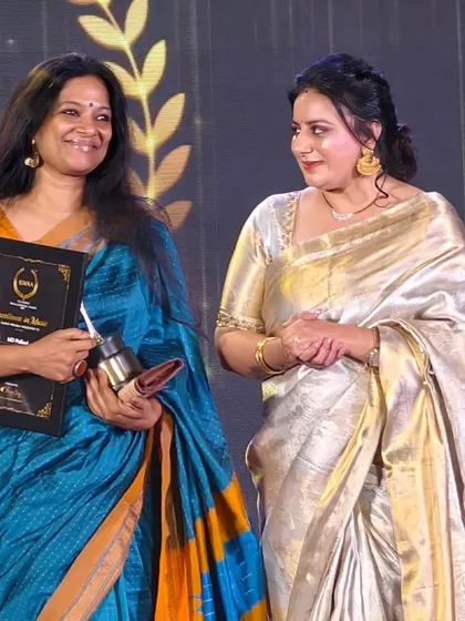 A candid moment on stage after receiving the award. I am grateful for the support of my family, my collaborators, and my audience.