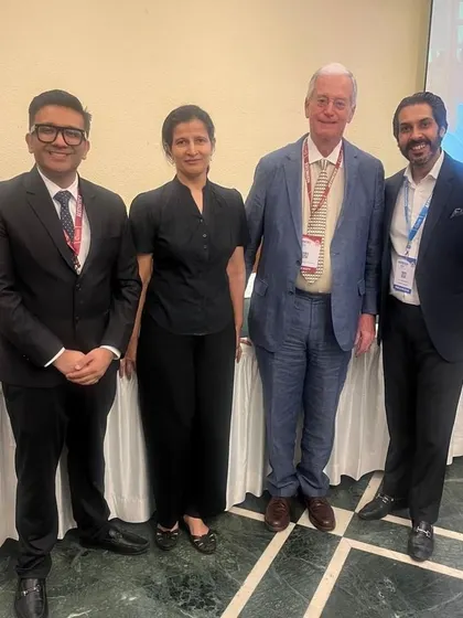 Posing with my respected colleagues at a professional event. Continuous education and collaboration are key pillars of our practice at Ojas Skin Care.
