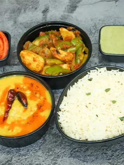 A classic North Indian meal combination. This plate features our flavourful Dal Tadka, a dry vegetable sabzi, and steamed rice for a complete and healthy meal.