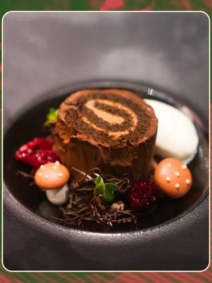 The decadent Yule Log dessert from our Christmas menu. This chocolate roulade, served with edible mushrooms and berry compote, was a festive showstopper.