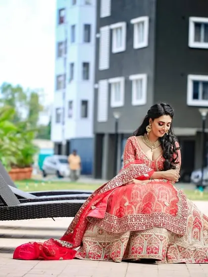 Our model relaxing by the poolside in the bridal lehenga, showing its versatility for different photo opportunities on your special day.