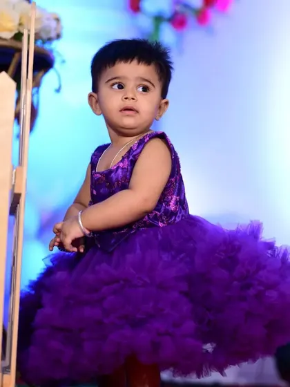 This custom purple gown is designed to be the centerpiece of any birthday celebration. Its vibrant color and dramatic ruffles ensure your child will be the center of attention.