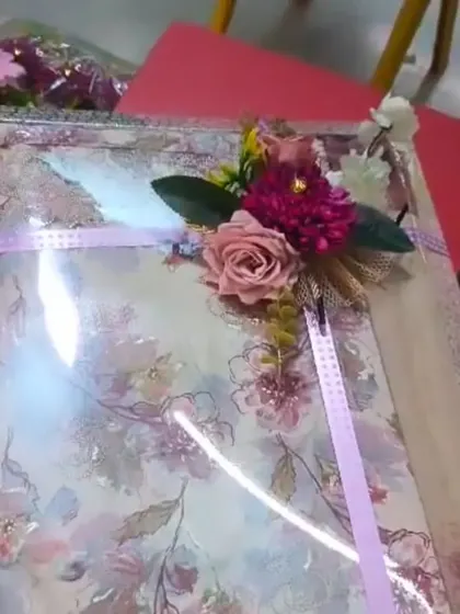 A floral printed suit packed in a tray, decorated with a matching floral bunch.