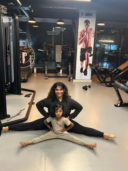 A demonstration of a full split, a result of consistent yoga and flexibility training. I incorporate stretching into my programs to ensure muscle recovery and a full range of motion.
