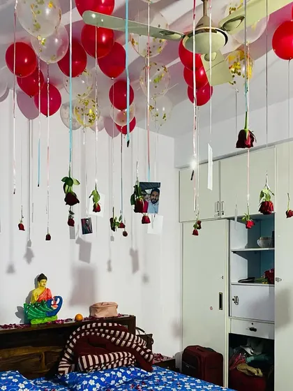 A close-up of the hanging photos and roses, a beautiful way to personalize a romantic decoration.