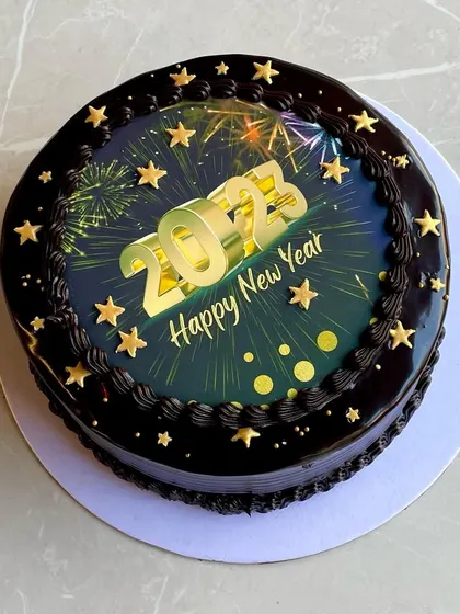 A dazzling chocolate cake to welcome the New Year, featuring an edible image of fireworks and stars.