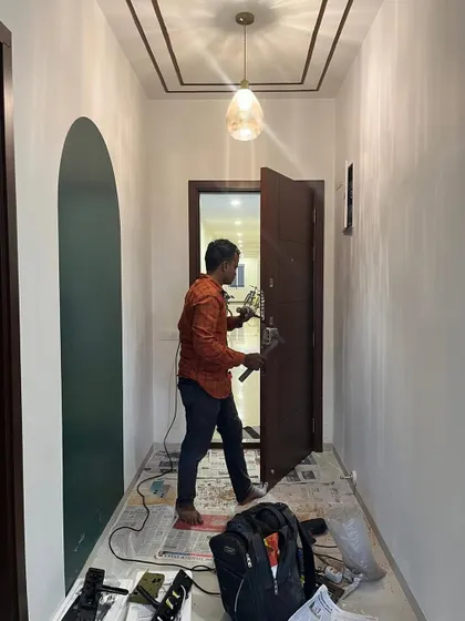 Who is the main character here? The carpenter installing the door lock, or the beautiful light casting a glow on the finished entryway? We think it's both.