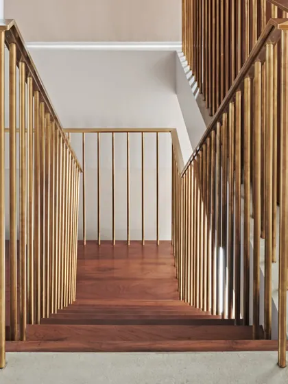 The clean, geometric lines of the brass balustrade and teak steps in the Maximum City Duplex staircase, showcasing our attention to detail and craftsmanship.