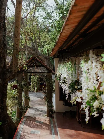 A view of the venue's walkway, decorated with hanging white floral strings.