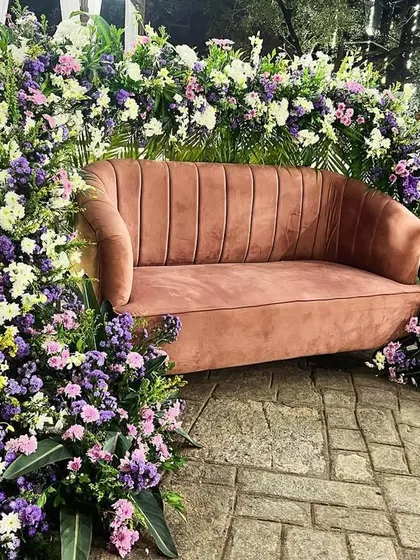 A unique floral-framed seating area, perfect for photos at a sangeet or reception.
