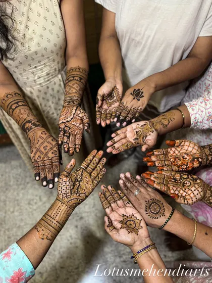 A beautiful moment with the bride's family and friends. We love creating a festive atmosphere where everyone gets a unique design, showcasing our team's ability to handle large groups efficiently.