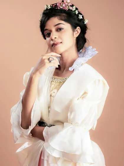 A portrait from our vintage-themed shoot. The makeup is understated to let the unique wardrobe and the model's expression shine, showing my ability to adapt to any creative brief.