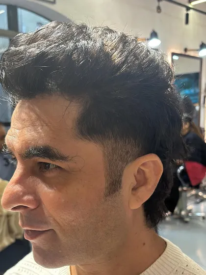 A closer look at the detail in a burst fade. Notice how the hair tapers down to the skin just behind the ear.