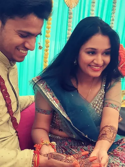 A sweet, candid moment between the bride and groom during their mehndi ceremony.