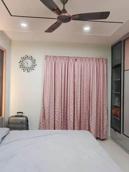This view captures the entire bedroom, where the unique wardrobe design serves as a stunning focal point.