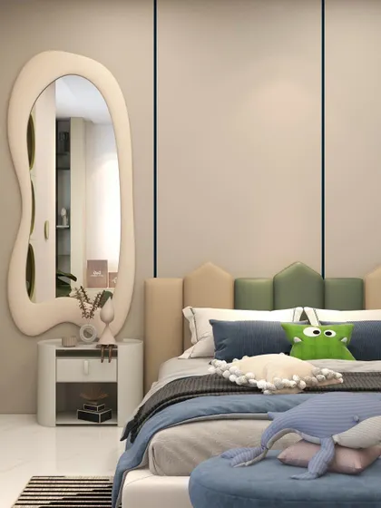 A close-up of the bed and the organically shaped mirror, which adds a whimsical and modern element to the room.