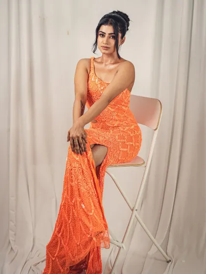 Posed elegantly, this shot shows the versatility of the orange gown. It's as perfect for a formal studio photoshoot as it is for a party.