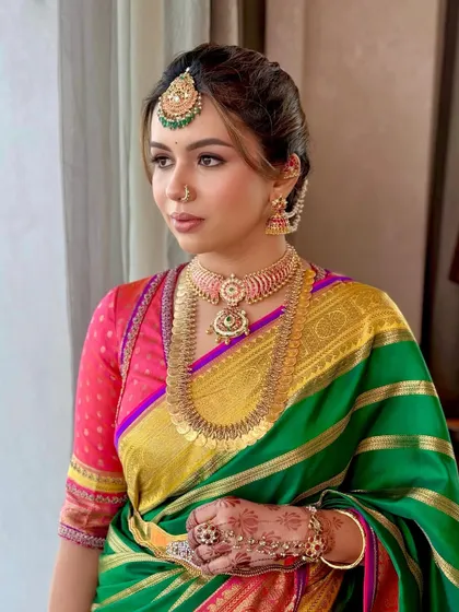 The quiet grace of a South Indian bride. This profile captures the serene beauty of Deeksha, with makeup that enhances her features while honoring the sanctity of the Muhurtham ceremony. It's a look that feels both classic and contemporary.