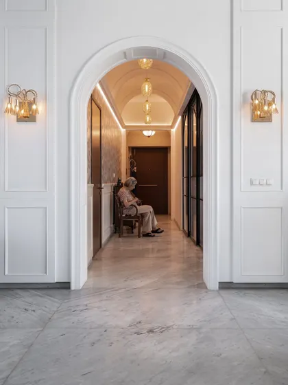 An arched corridor with classic wall sconces leads into the main living area, creating a beautiful sense of arrival. We believe these transitional spaces are just as important for setting the mood of a home.