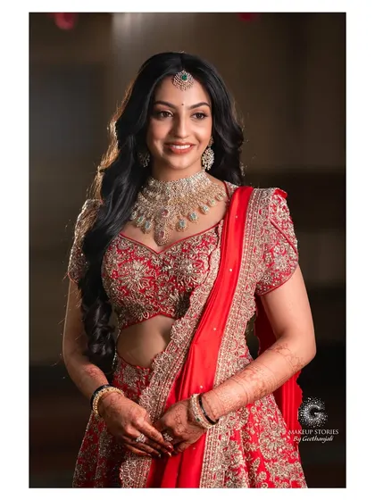 A smiling portrait of Likitha, showcasing her beautiful reception makeup. The look is a perfect balance of traditional elegance and modern glam, ideal for a Bangalore wedding reception.