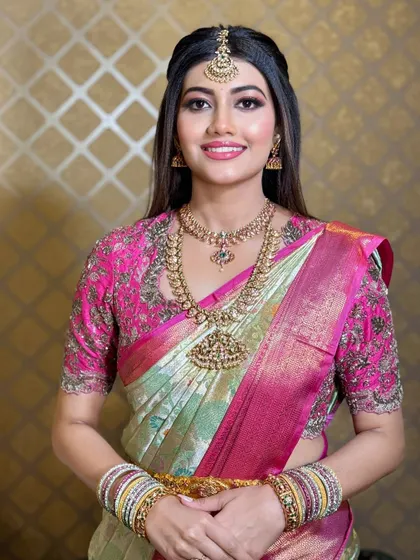 A bright and happy portrait of the bride. The makeup is clean and fresh, enhancing her beautiful smile.