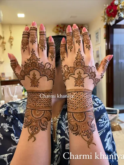 A simple yet beautiful henna pattern. The design is focused on the back of the hand, with a delicate wristband and finger details.