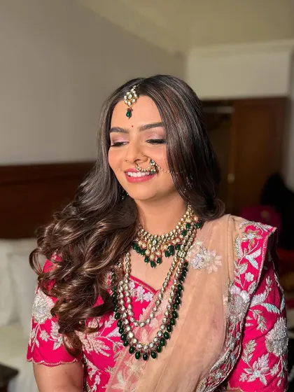 This bride chose to wear her hair down in soft, glamorous waves for her wedding. It's a beautiful choice for a modern bride who wants to feel comfortable and look stunning.