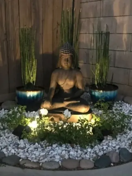 A peaceful Buddha-themed garden I designed for a client's corner space. The use of uplighting, white pebbles, and tall, slender plants creates a serene atmosphere, especially at night.