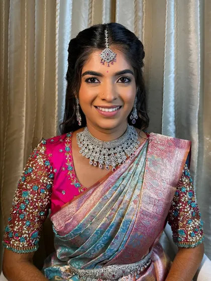 A smiling portrait of the bride. Her makeup is fresh and radiant, perfect for her reception celebration.
