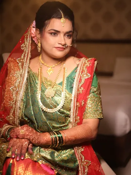 A portrait of the bride, showcasing the complete makeup look. The base is smooth and skin-like, with soft contouring to define her features and eye makeup that makes her eyes pop.