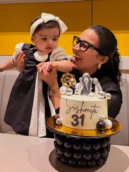 A playful shot from my birthday, where Gauri is reaching for the cake. It's a cute, authentic moment that captures the reality of celebrating anything with a toddler.