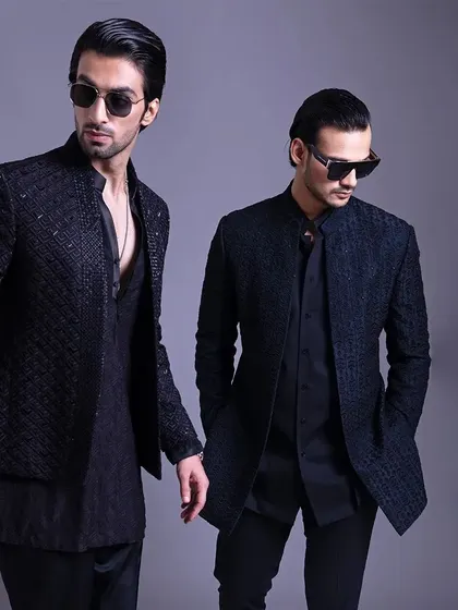 Two variations of the black textured Indo-Western look. This shows the versatility of the design, suitable for different personal styles while maintaining a cohesive, powerful aesthetic.