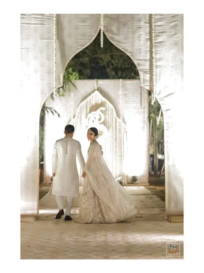 The couple walking away, with the bride looking back, creating a cinematic feel.