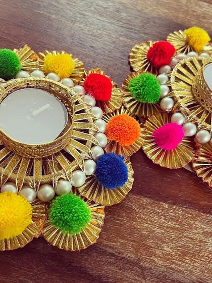 A pair of our handmade tea light holders sitting on a wooden surface. They look beautiful as a set and can be used to frame a deity or decorate a dining table for a festive meal.