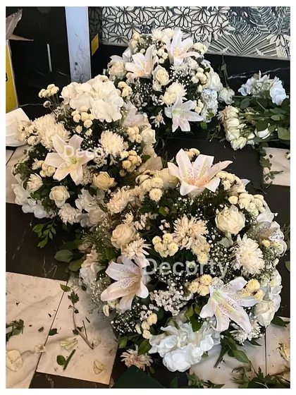 Bouquets of fresh white flowers being prepared for a corporate launch event. I use high-quality florals to add a touch of class and sophistication to any occasion.