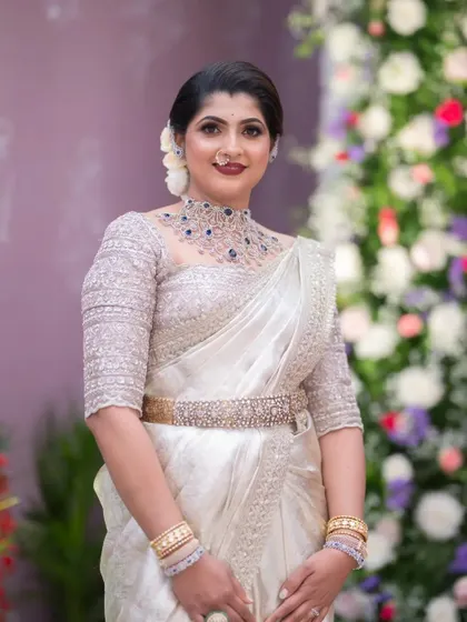 A full-length shot of this elegant wedding guest. Her makeup is classic and polished, perfect for the occasion.